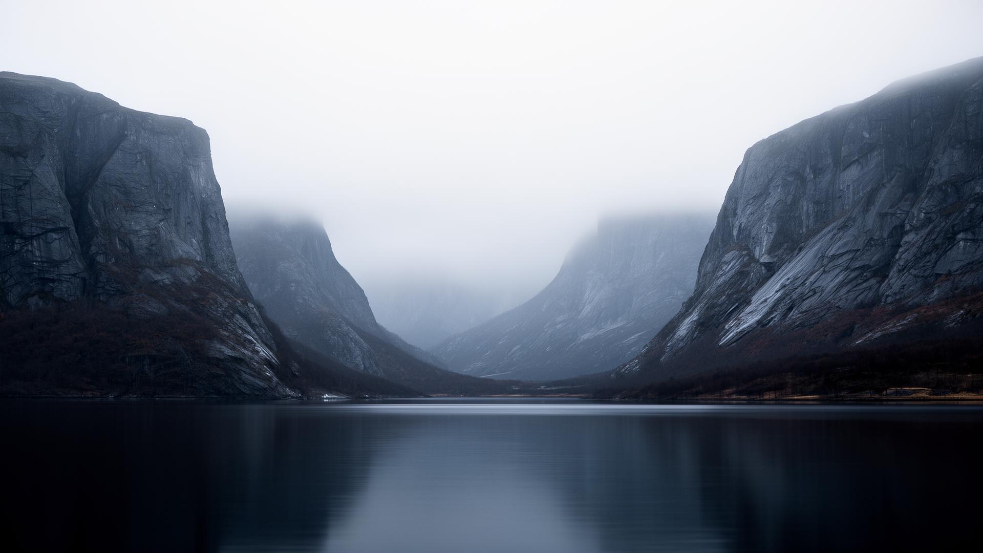 A still grey fjord at dawn — cold light between stone cliffs, the north that runs in the bloodline.