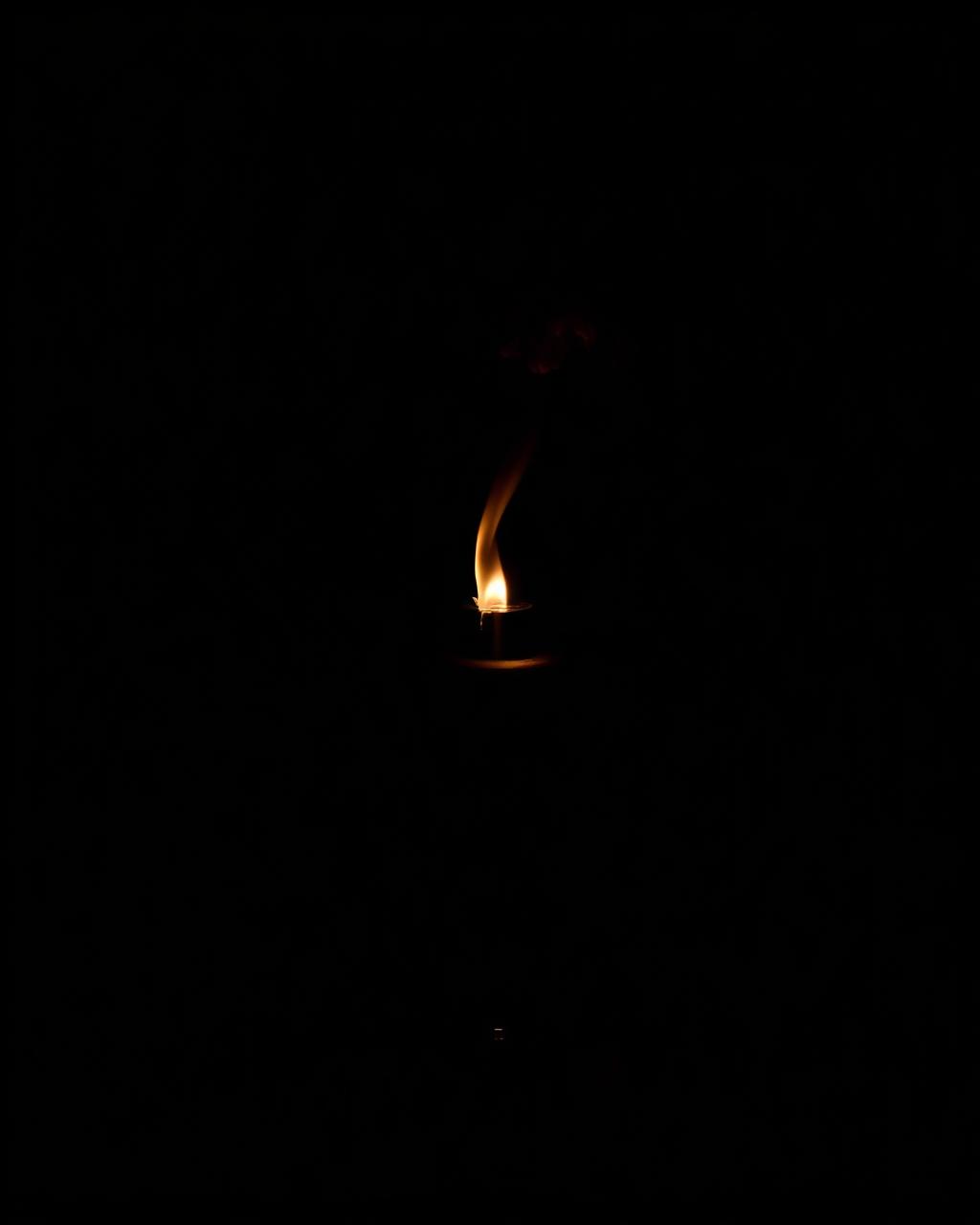 Vespro — dark bottle in candlelit shadow.
